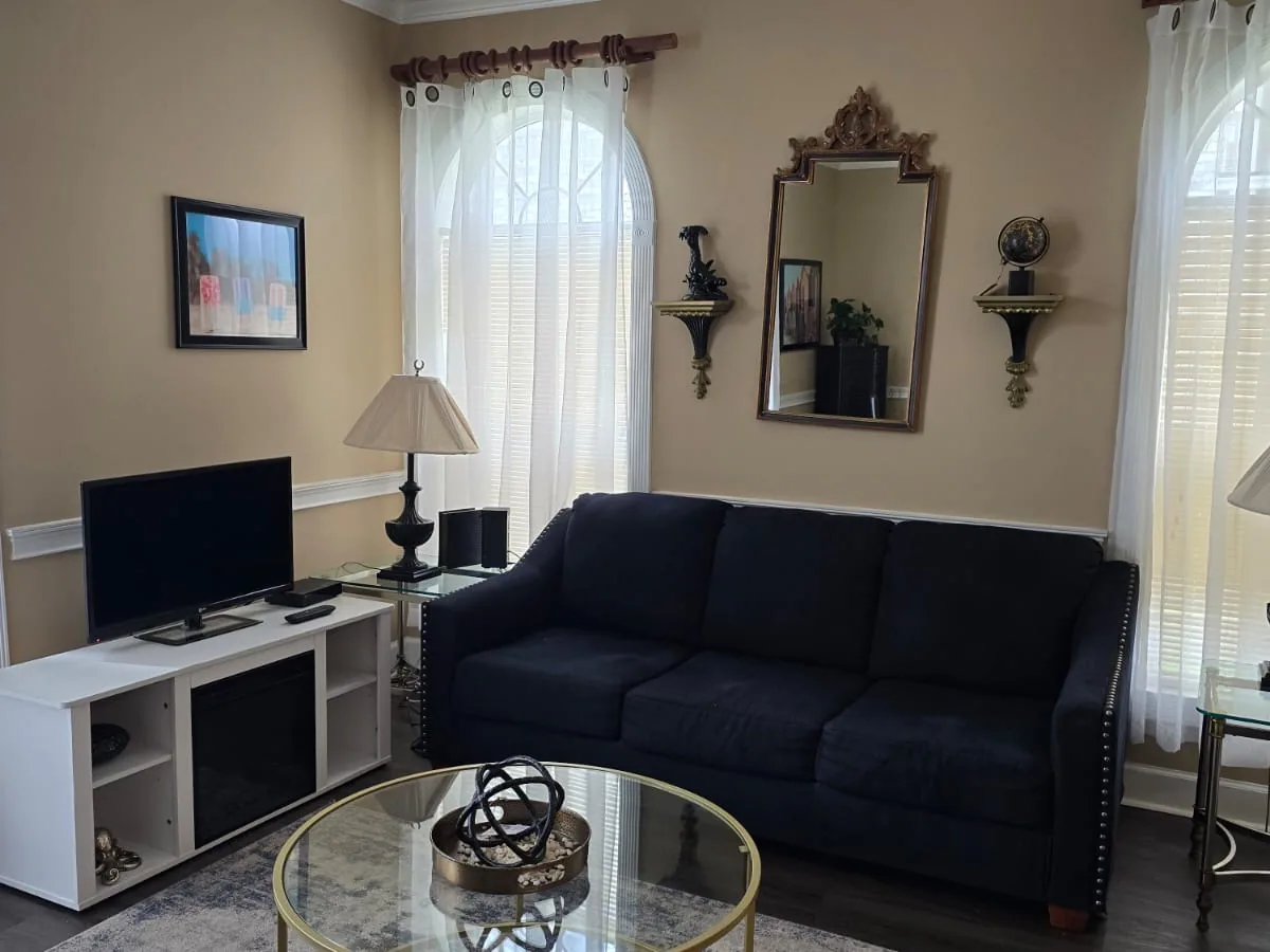 Dusted television console and wiped glass coffee table